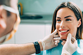 Dentist inspecting woman's teeth