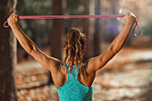 Woman exercising with elastic band outdoors