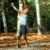 Woman stretching with elastic band outdoors