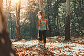 Woman jogging outdoors in autumn