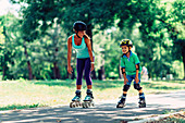 Mother teaching son to roller skate in park