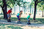 Family roller skating in park