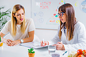 Nutritionist with female patient