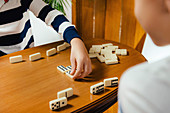 Schoolboy playing dominoes