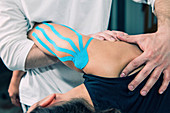 Physical therapist treating shoulder