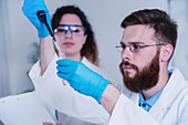 Researcher using micropipette
