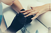Woman having manicure