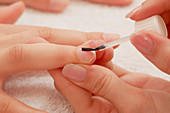 Woman having manicure