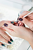 Nail technician painting nails