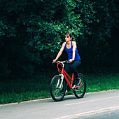 Woman cycling in a park