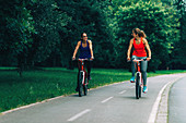 Two women cycling together