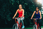 Two women cycling together