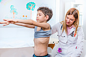 Paediatrician examining boy's spine