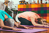 Senior woman in private yoga class