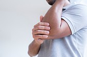 Man touching his elbow in pain
