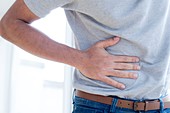 Man touching his stomach in pain
