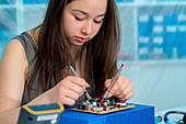 Girl working on electronics project