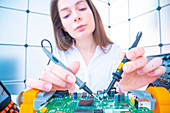 Engineer working on circuit board