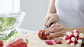 Woman chopping tomato