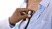 Woman having chest examined with stethoscope