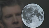 Man looking at the Moon on a screen