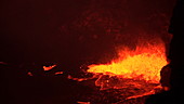 Lava spattering at night