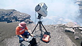 Volcanologist surveys lava lake