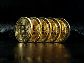 Row of shiny new gold bitcoins, illustration