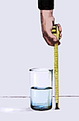 Man measuring water with tape measure, illustration