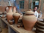 Chinese potter in his workshop