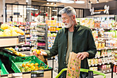 Man shopping for fruits in a supermarket