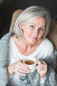 Woman drinking hot beverage