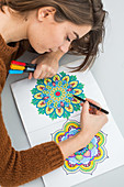 Woman colouring a mandala
