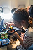 Child eating a meal on airplane