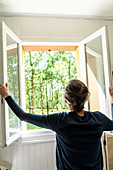 Woman opening window