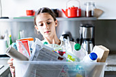 Young girl sorting recycled wastes