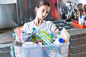 Young girl sorting recycled wastes