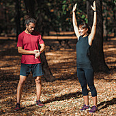 Young couple stretching after training in the park