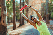 Woman exercising with resistance band outdoors