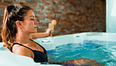 Woman enjoying hot tub in a spa