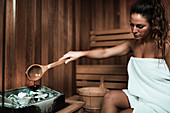 Woman relaxing in sauna