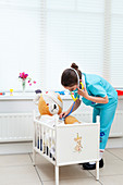 Girl nursing her teddy bear