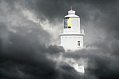 Lighthouse surrounded by clouds