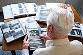 Senior man looking at photo albums