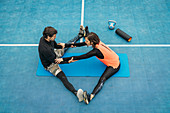 Young woman stretching after training