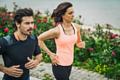 Fit young couple jogging outdoors