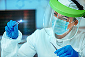 Scientist examining RFID implant chip