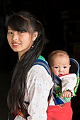 Black Hmong woman with her child
