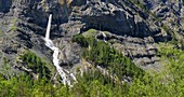 Waterfall emerging from karst cave