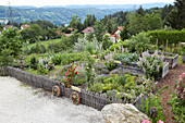 Raised permaculture beds in idyllic cottage garden